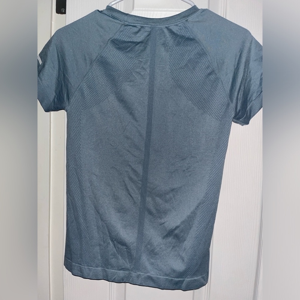 blue athletic top size L runs small
